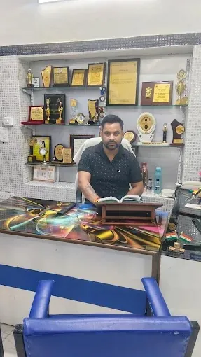 Dr. Bhatt at his desk in front of his awards shelf