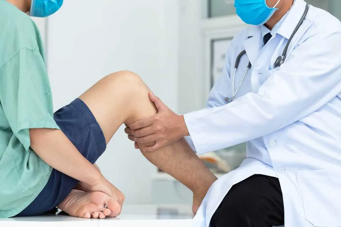 Doctor examining a patient's knee